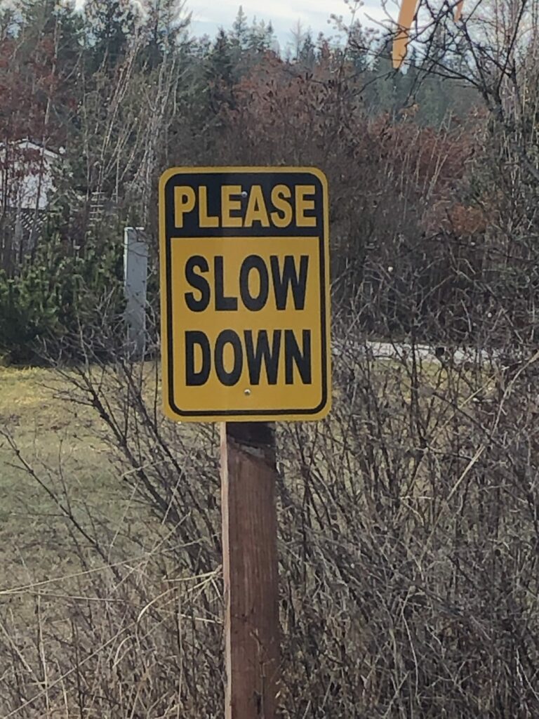 slow down road sign