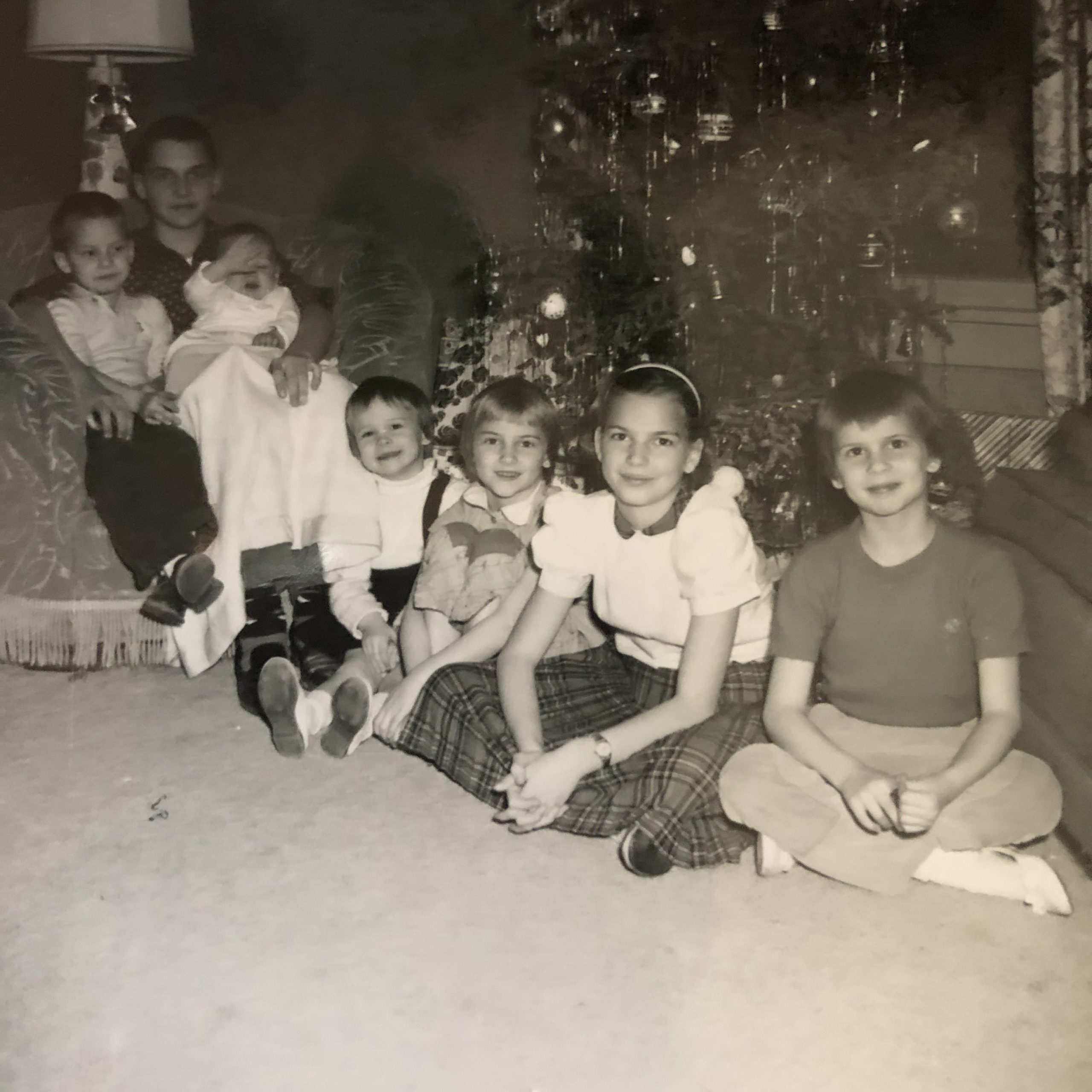 7 kids near a Christmas tree