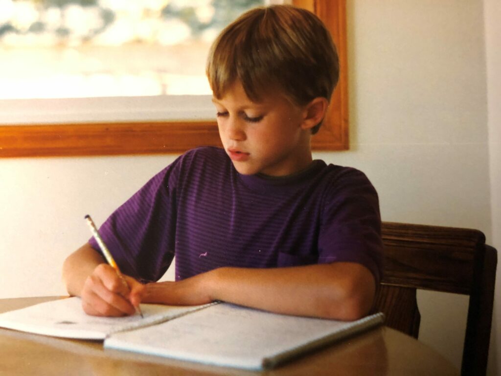 kid writing on a piece of paper