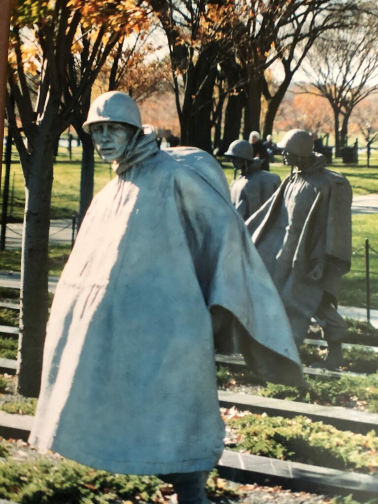 statues of people with hats and raincoats