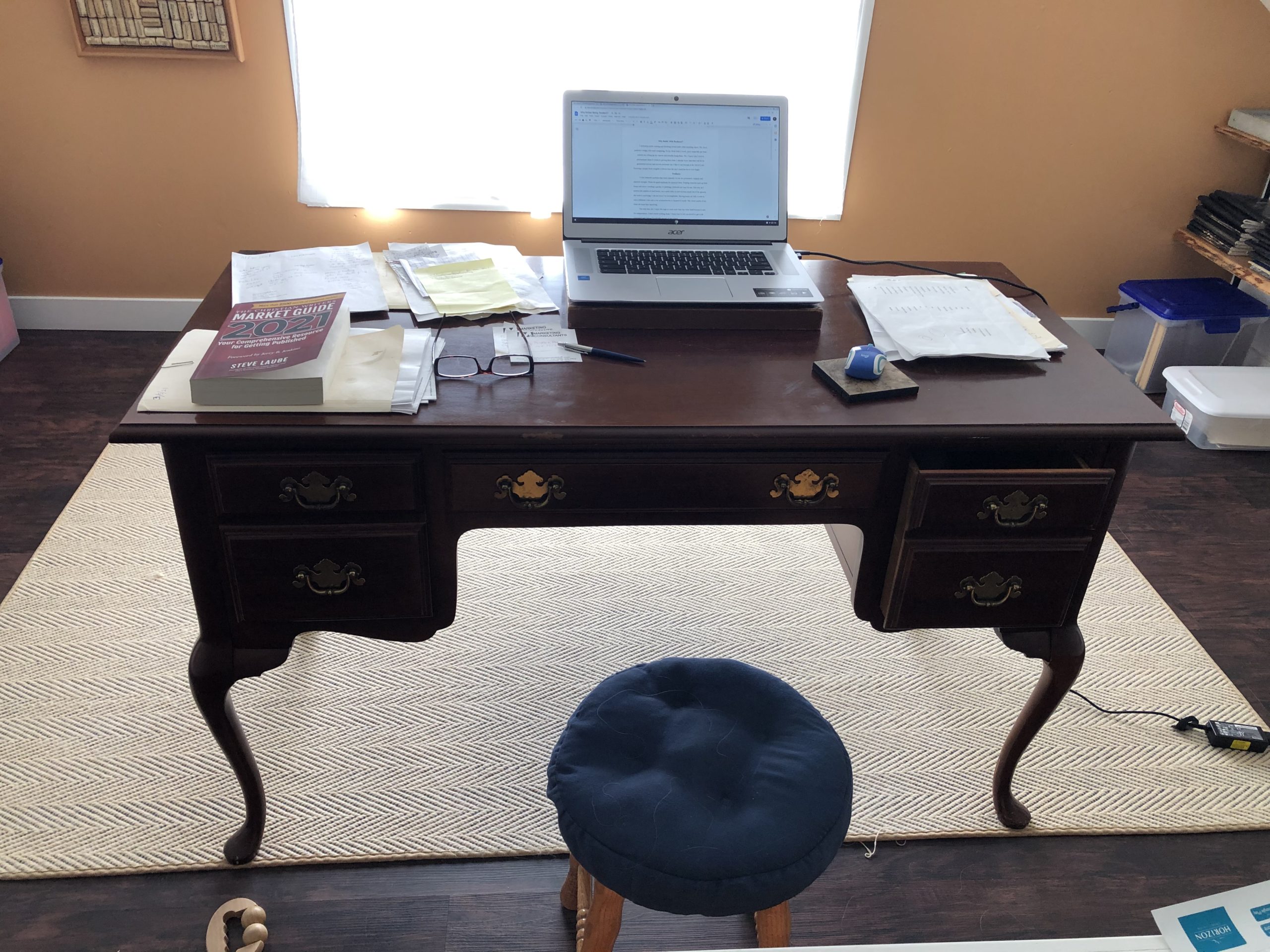 desk with a laptop and paper