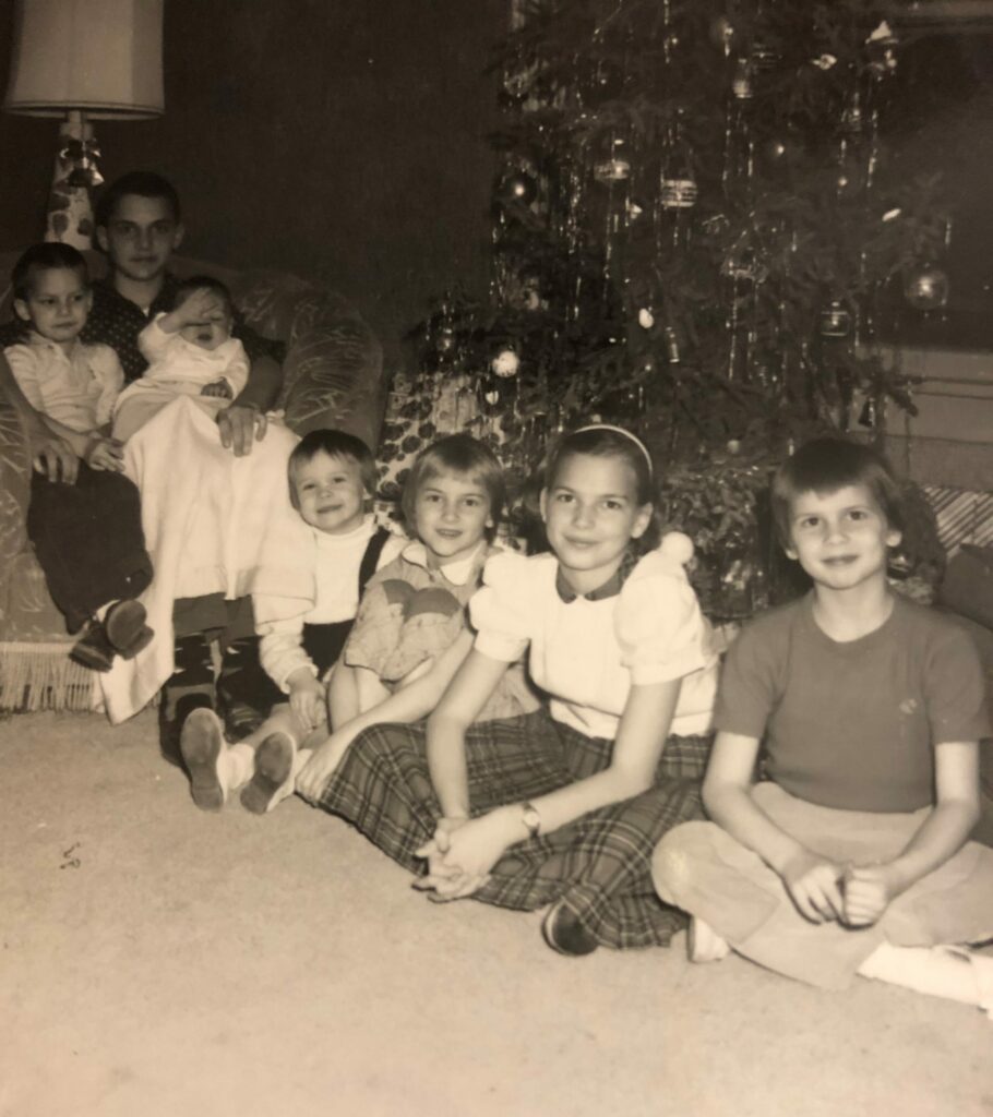 black and white photo of kids near a christmas tree