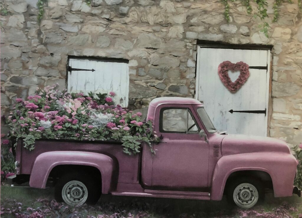 old pink pick-up truck with flowers