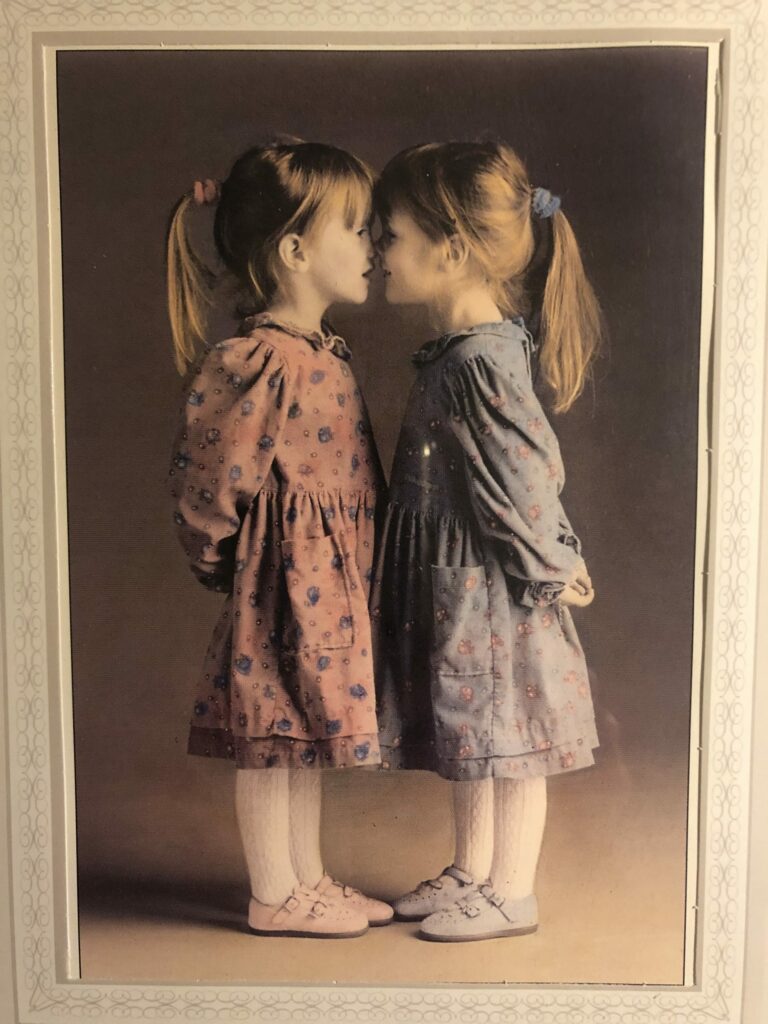 photo of 2 girls with their nose touching