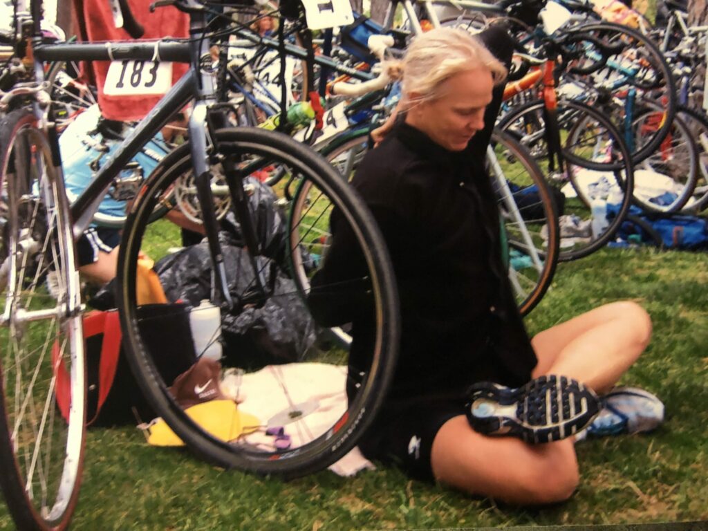 Terese Luikens sitting with bicycles behind her